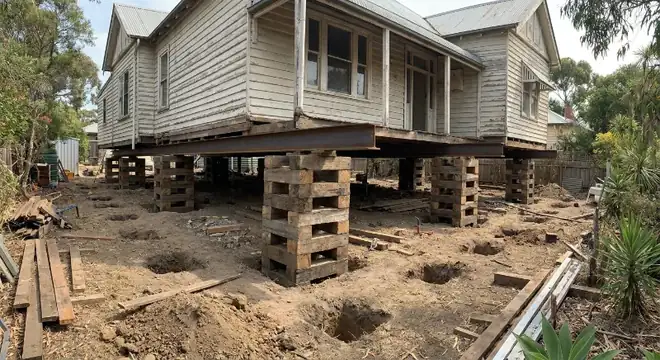 A dropped section of subfloor with failed supports exposed
